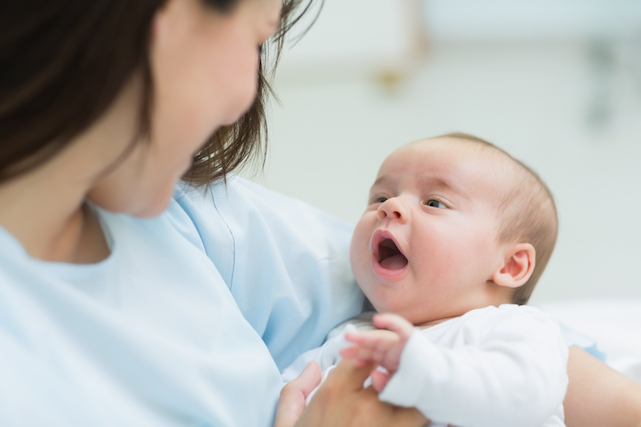 A mother holding her newborn baby