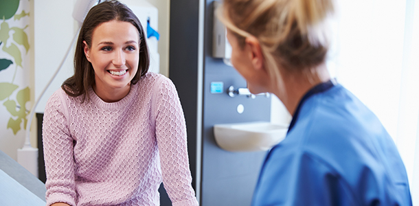 Female patient smiling and talking to doctor