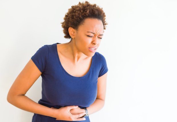 Woman holding her stomach in pain