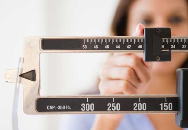 woman looking at scale woman looking at scale