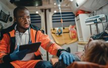 An EMS technician in an ambulance with a patient